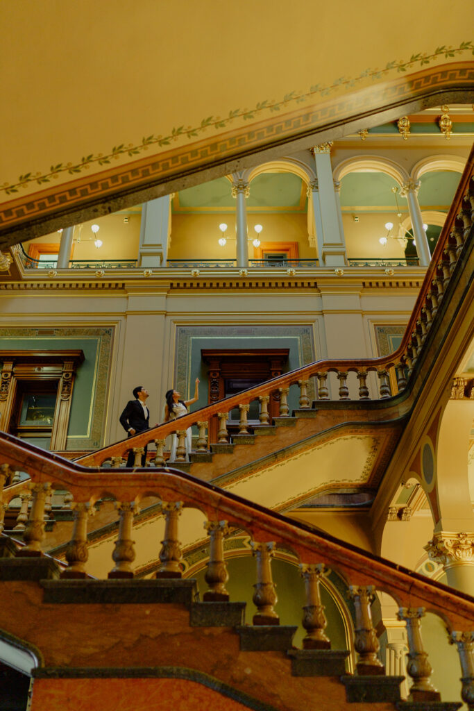 Iowa capitol elopement - grand staircase with couple admiring scenery