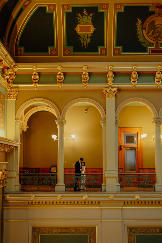 Iowa capitol elopement - couple embracing surrounded by architecture