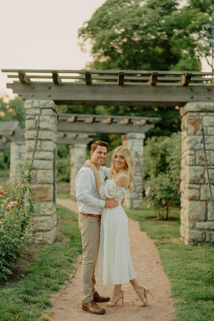 Classic Couple embracing by arches