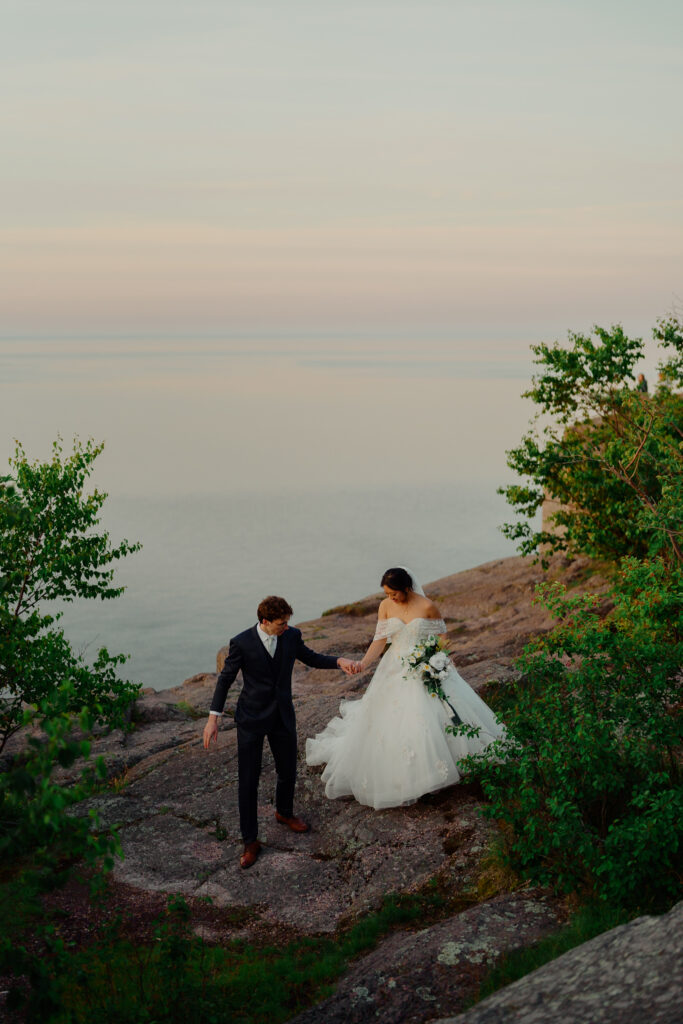 Eloping couple holding hands and walking