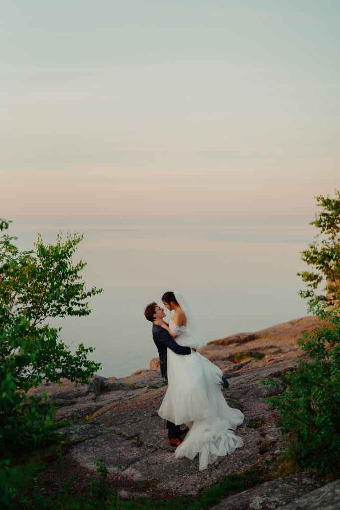 Eloping couple embracing with a kiss