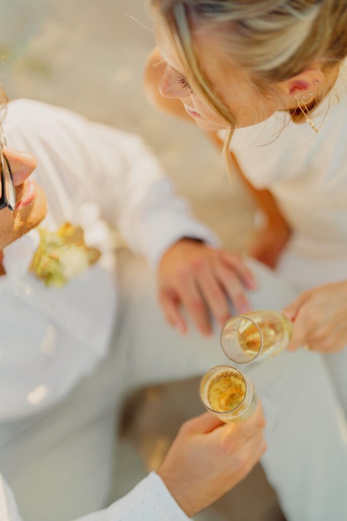 couple sipping champagne and holding champagne flutes