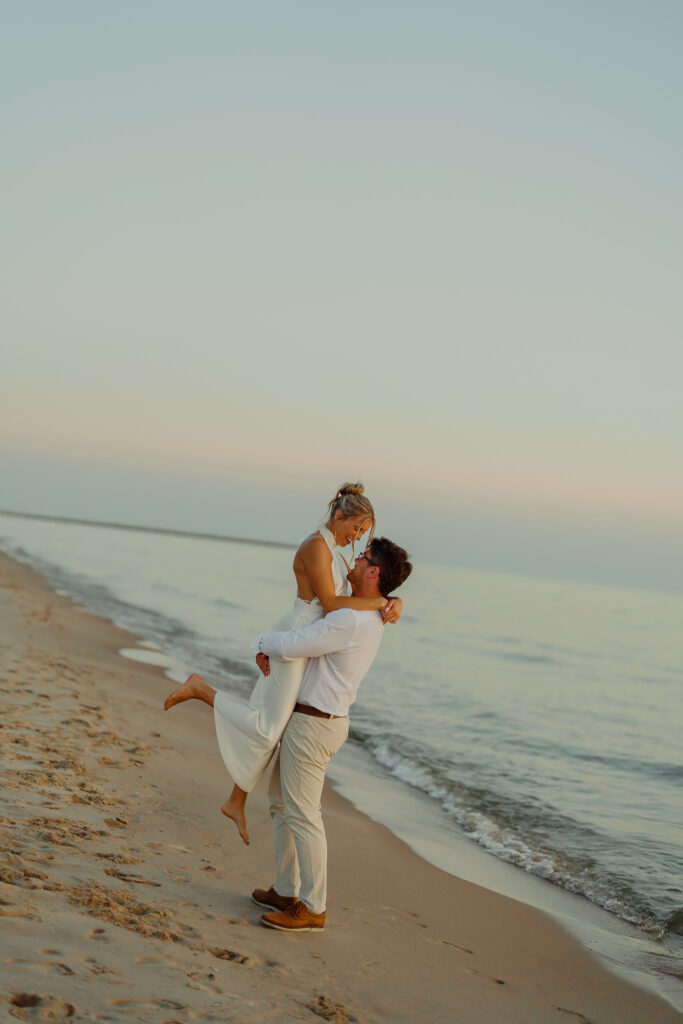 Man holding woman up in the air, romantic elopement photographer