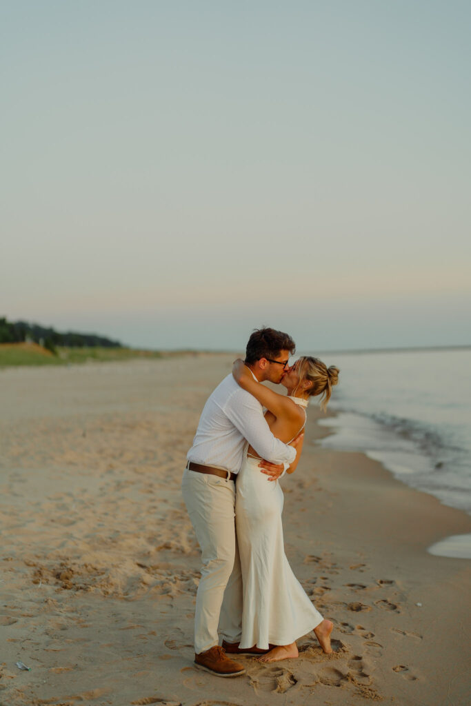 Romantic Michigan elopement photographer couple kissing on the beach