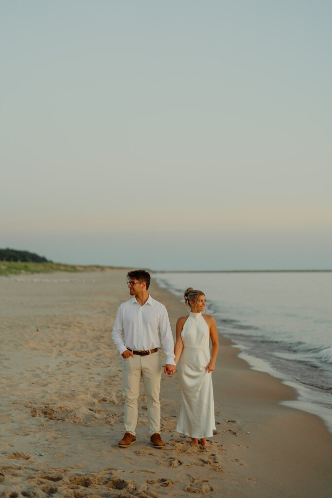 Couple staring off into opposite directions while holding hands