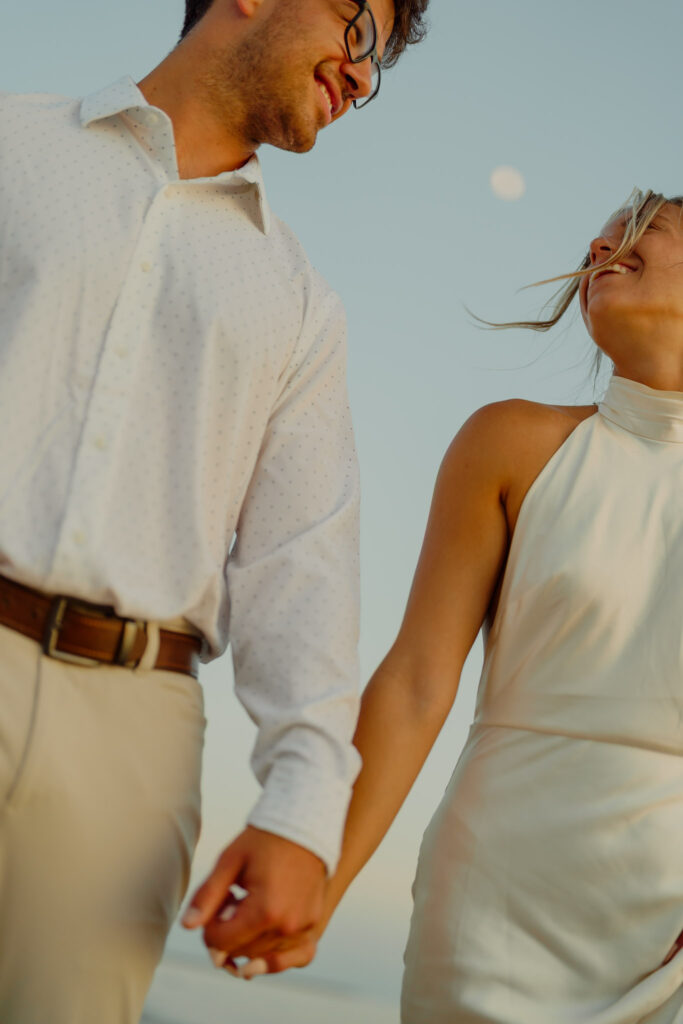 Woman smiling at man while they hold hands