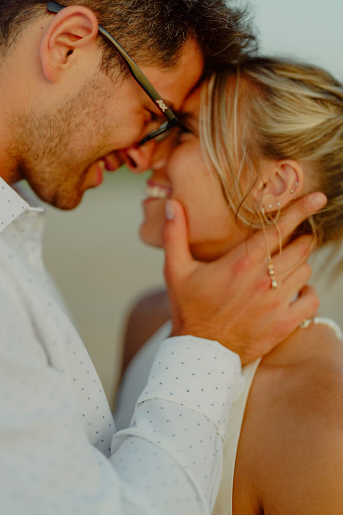 man holding womans face and touching foreheads