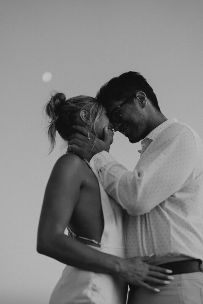 black and white couple in soft embrace and touching foreheads