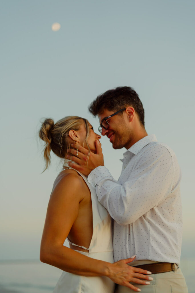 Couple sharing tender hug at beach elopement