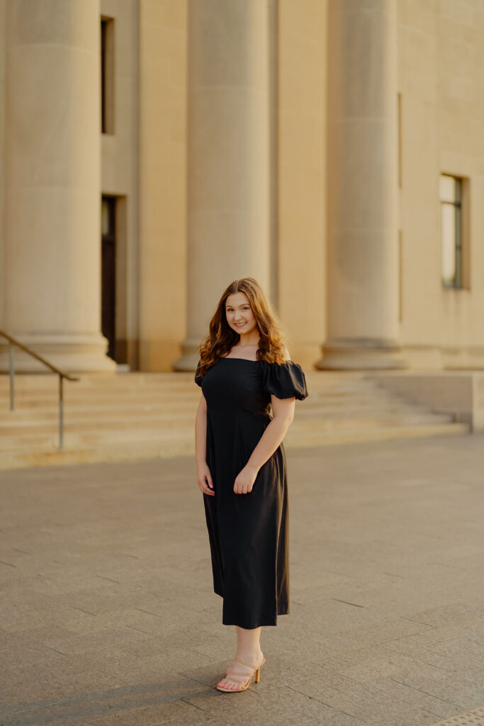 Professional business headshot of woman at Nelson-Atkins Museum in Kansas City with columns backdrop and woman smiling