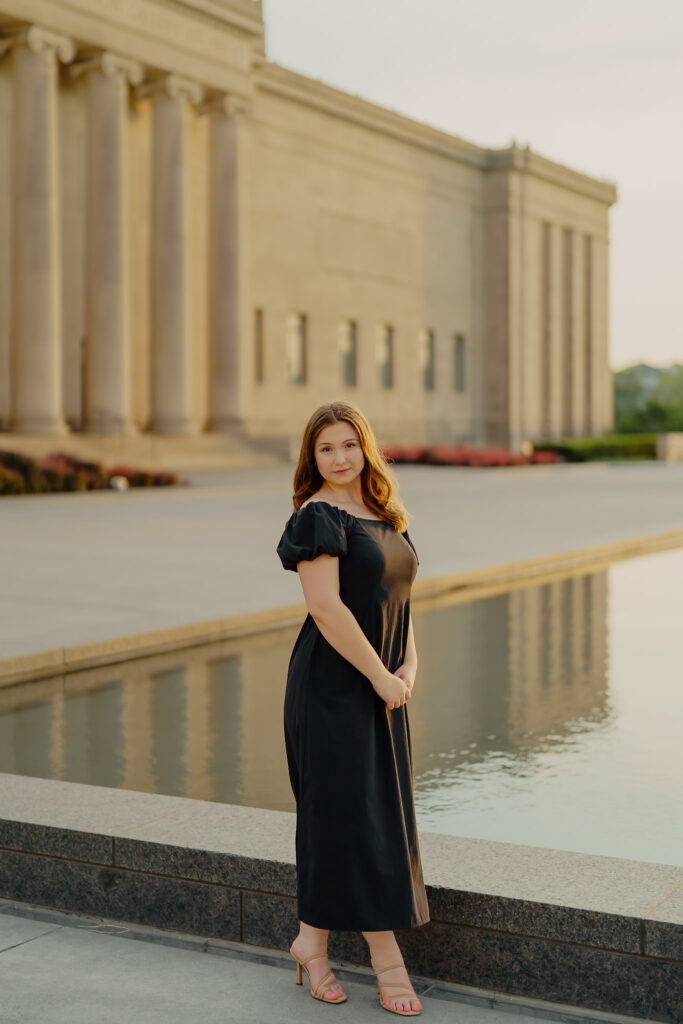 Modern Kansas City business headshots with waterfront backdrop at Nelson-Atkins tight lip smile
