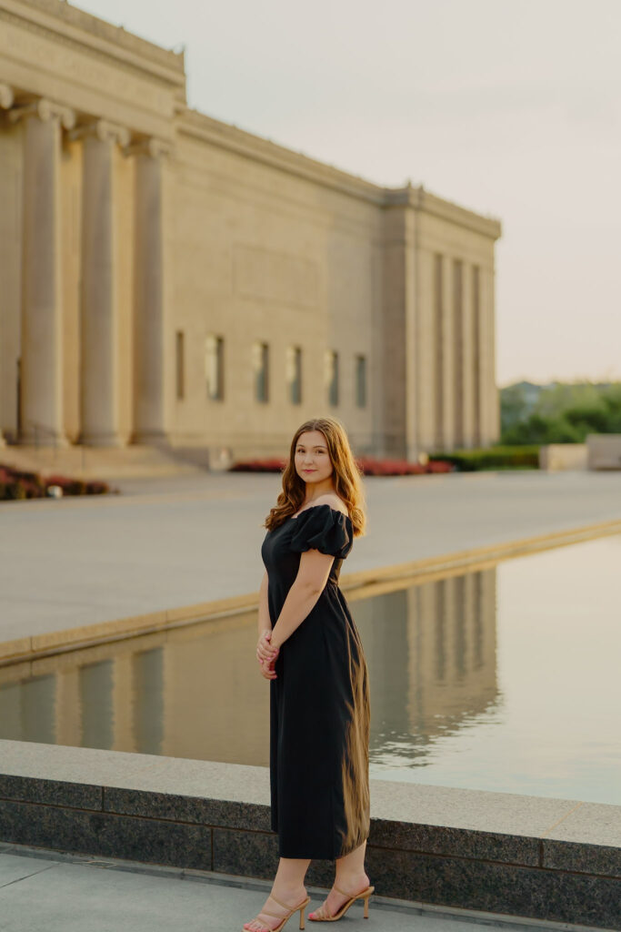 Modern Kansas City business headshots with waterfront backdrop at Nelson-Atkins tight lip smile