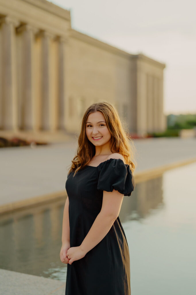 Modern Kansas City business headshots with waterfront backdrop at Nelson-Atkins smiling woman