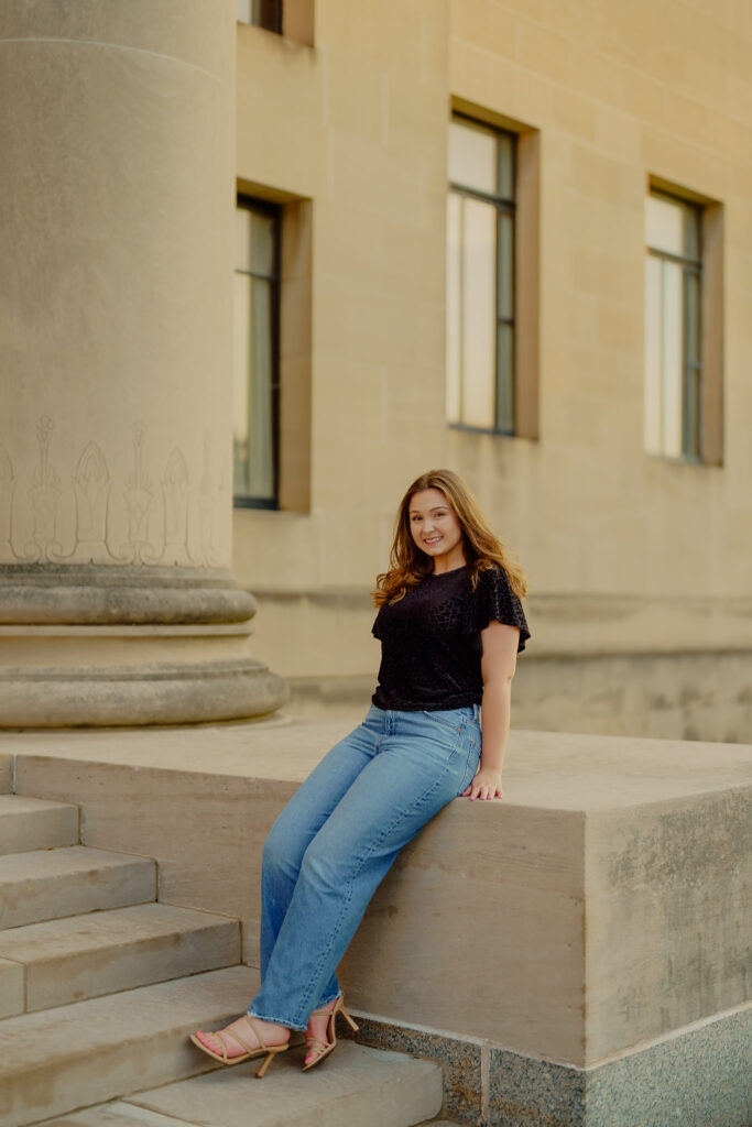 Modern Kansas City business headshots with greenery and marble walls at Nelson-Atkins leaning against marble