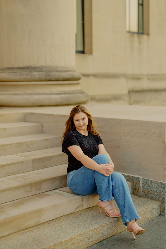 Modern Kansas City business headshots with greenery and marble walls at Nelson-Atkins sitting by stairs