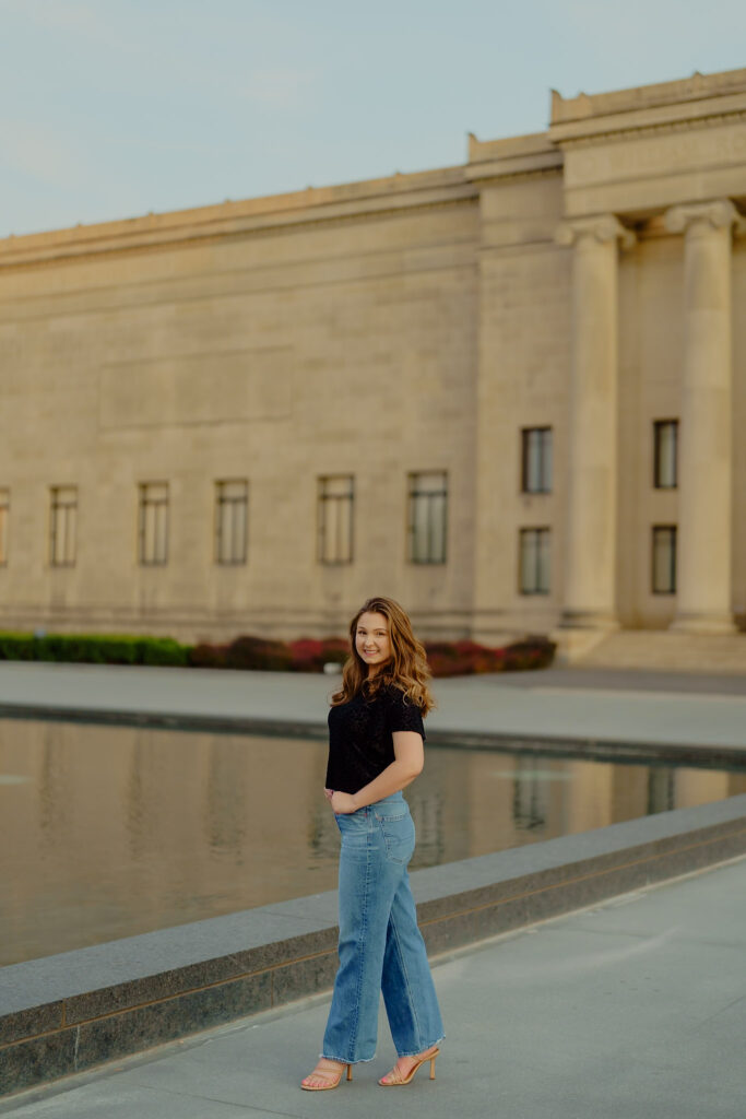 Corporate portrait of woman smiling in natural light at Nelson-Atkins Museum standing by the waterfront