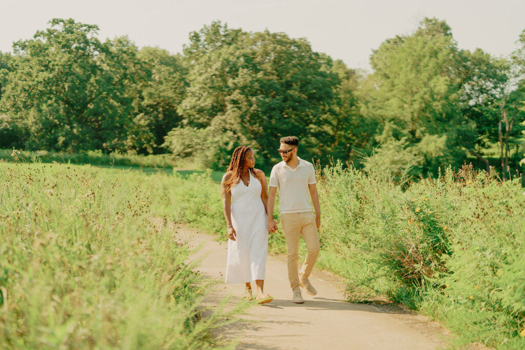 Couple walking together and holding hands at Powell Gardens