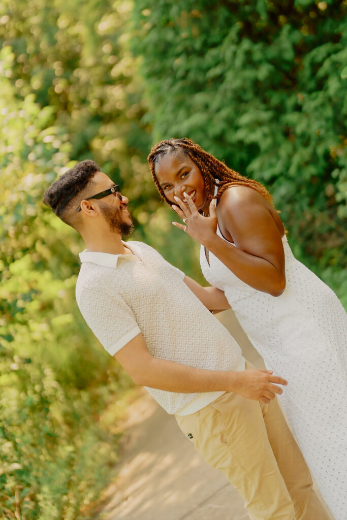 Surprise proposal at Powell Gardens, woman showing off ring
