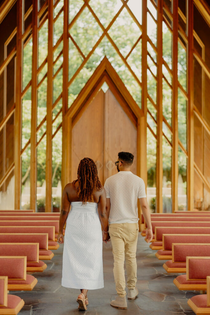 Romantic Powell Gardens proposal in Missouri couple walking in chapel holding hands