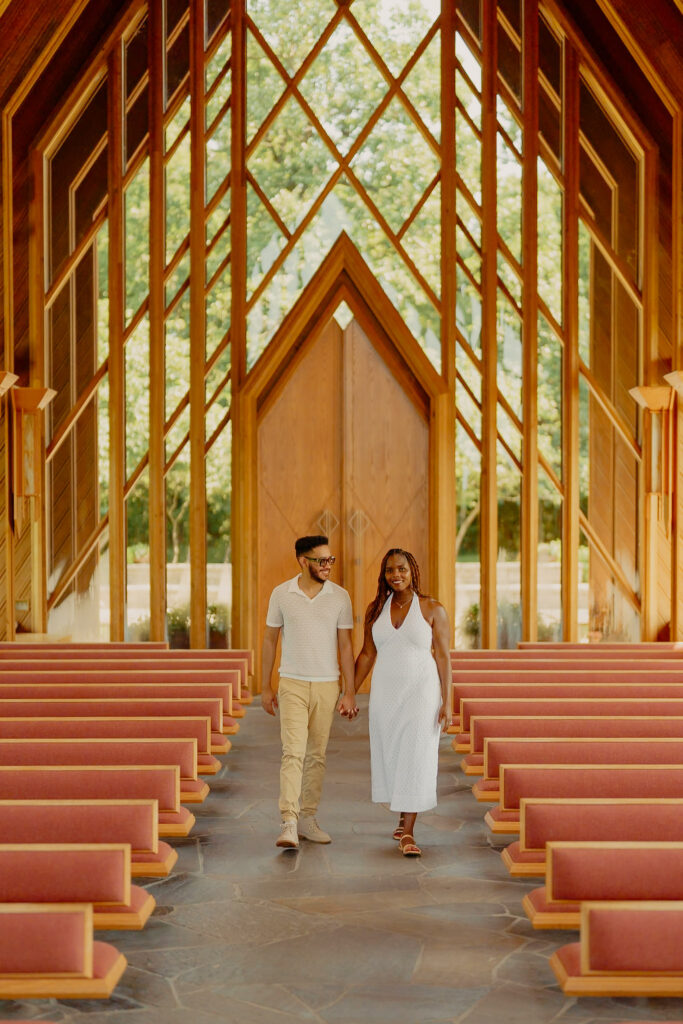 Romantic Powell Gardens Chapel couple holding hands and walking together