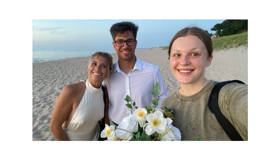Michigan elopement photographer posing with eloping couple